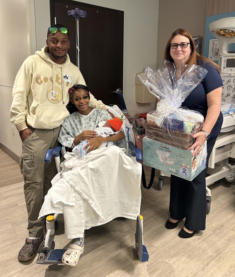Local troops gift new mom with Girl Scouts-inspired gift basket for first baby girl born at Broward Health Coral Springs on Halloween